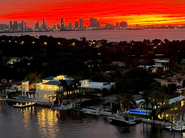 a living room with stainless steel appliances kitchen island granite countertop furniture and a flat screen tv