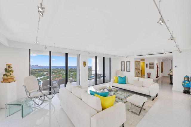 a large kitchen with stainless steel appliances a large window and a counter space