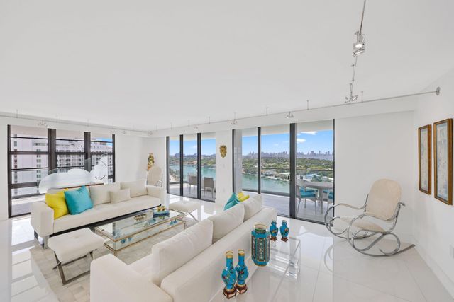 a bedroom with a bed a television and a large window