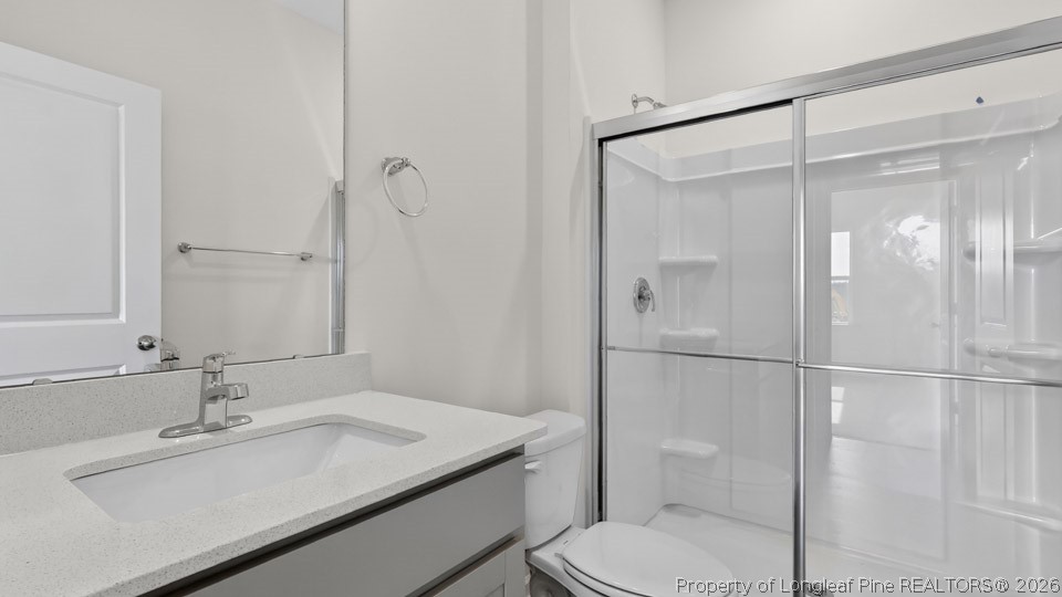 115 Discovery Way Spring Lake, NC 28390 - Photo 23 of 30 a bathroom with a granite countertop sink toilet and shower