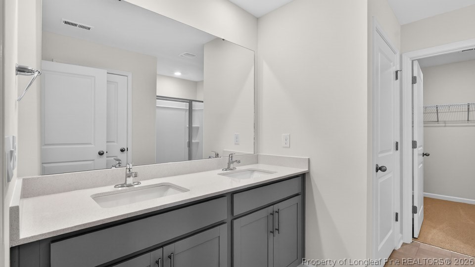 115 Discovery Way Spring Lake, NC 28390 - Photo 24 of 30 a bathroom with a sink and a mirror
