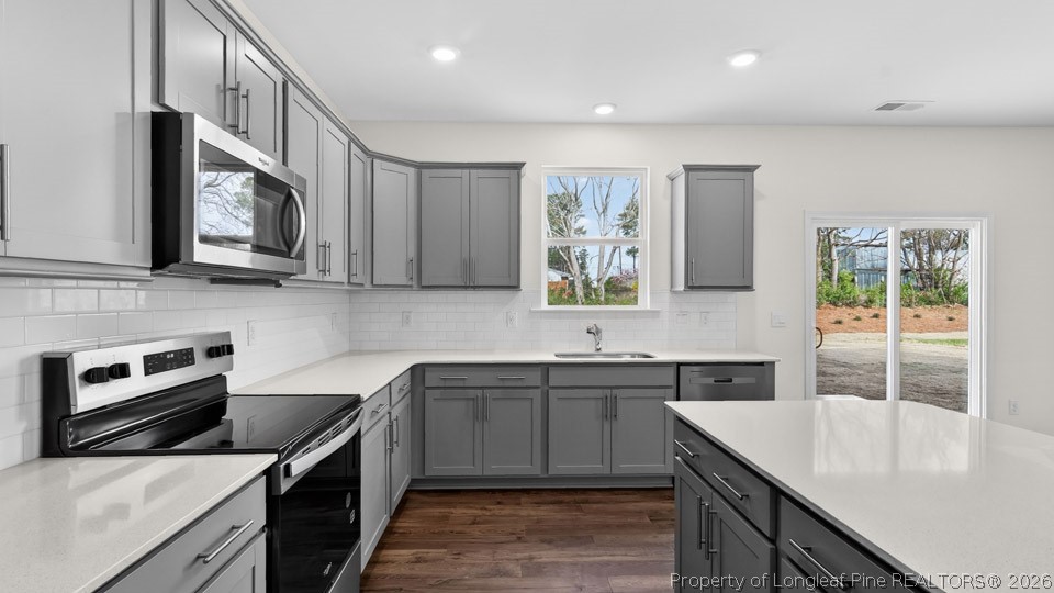 115 Discovery Way Spring Lake, NC 28390 - Photo 3 of 30 a kitchen with stainless steel appliances granite countertop a sink stove and microwave