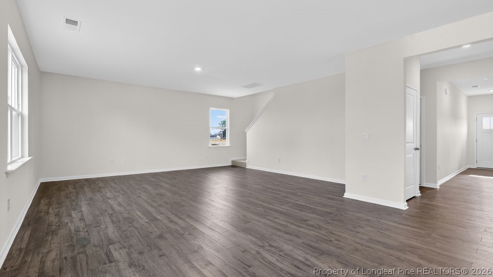 115 Discovery Way Spring Lake, NC 28390 - Photo 10 of 30 an empty room with wooden floor and windows