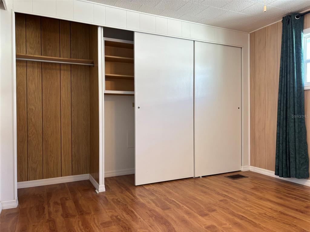 13225 101st Street Southeast, Unit 144 Largo, FL 33773 - Photo 14 of 33 a view of an empty room with wooden floor and closet area