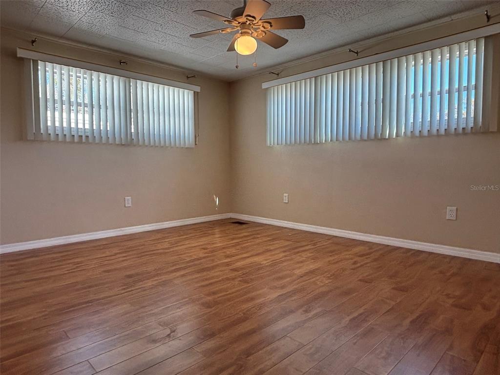 13225 101st Street Southeast, Unit 144 Largo, FL 33773 - Photo 18 of 33 a view of an empty room with wooden floor and a window