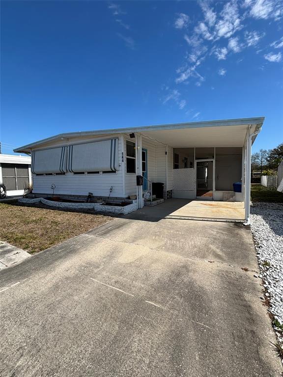 13225 101st Street Southeast, Unit 144 Largo, FL 33773 - Photo 2 of 33 a view of a house with a yard