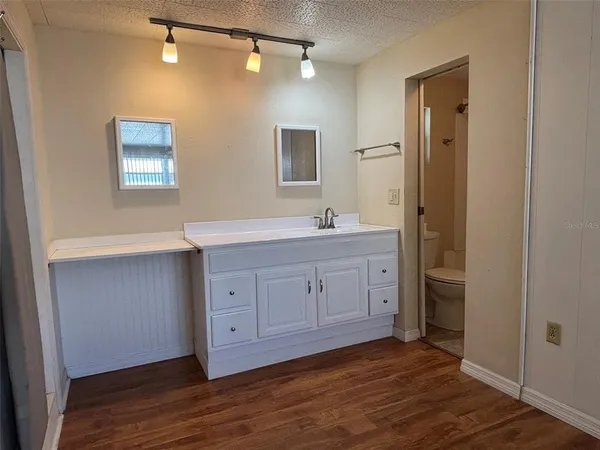 a bathroom with a double vanity sink a mirror and a shower