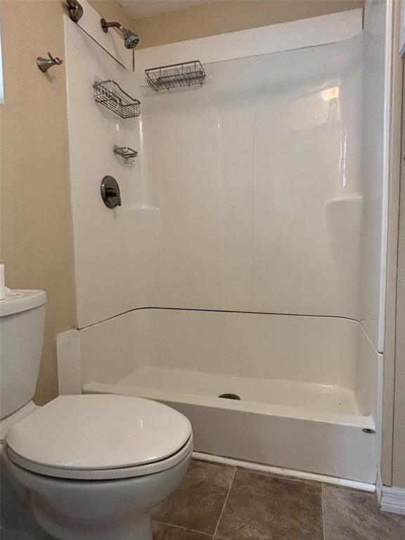 13225 101st Street Southeast, Unit 144 Largo, FL 33773 - Photo 22 of 33 a bathroom with a toilet and a shower