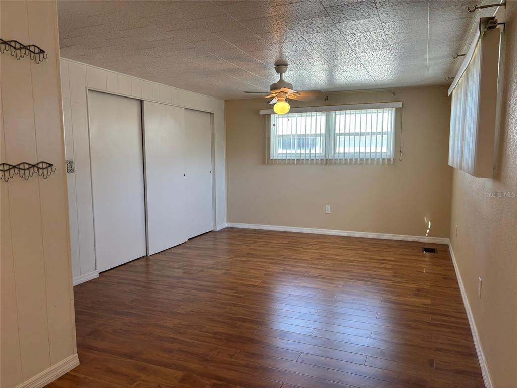 13225 101st Street Southeast, Unit 144 Largo, FL 33773 - Photo 23 of 33 a view of an empty room with wooden floor and a window