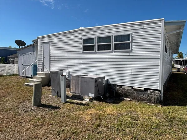 a view of a house with a yard and furniture
