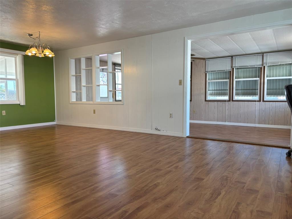 13225 101st Street Southeast, Unit 144 Largo, FL 33773 - Photo 8 of 33 an empty room with wooden floor and windows