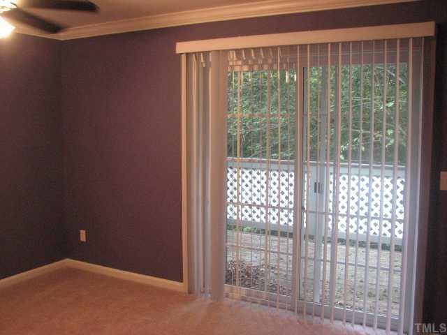 308 Broad Leaf Circle Raleigh, NC 27613 - Photo 8 of 10 Master bedroom with sliding glass doors onto private deck.