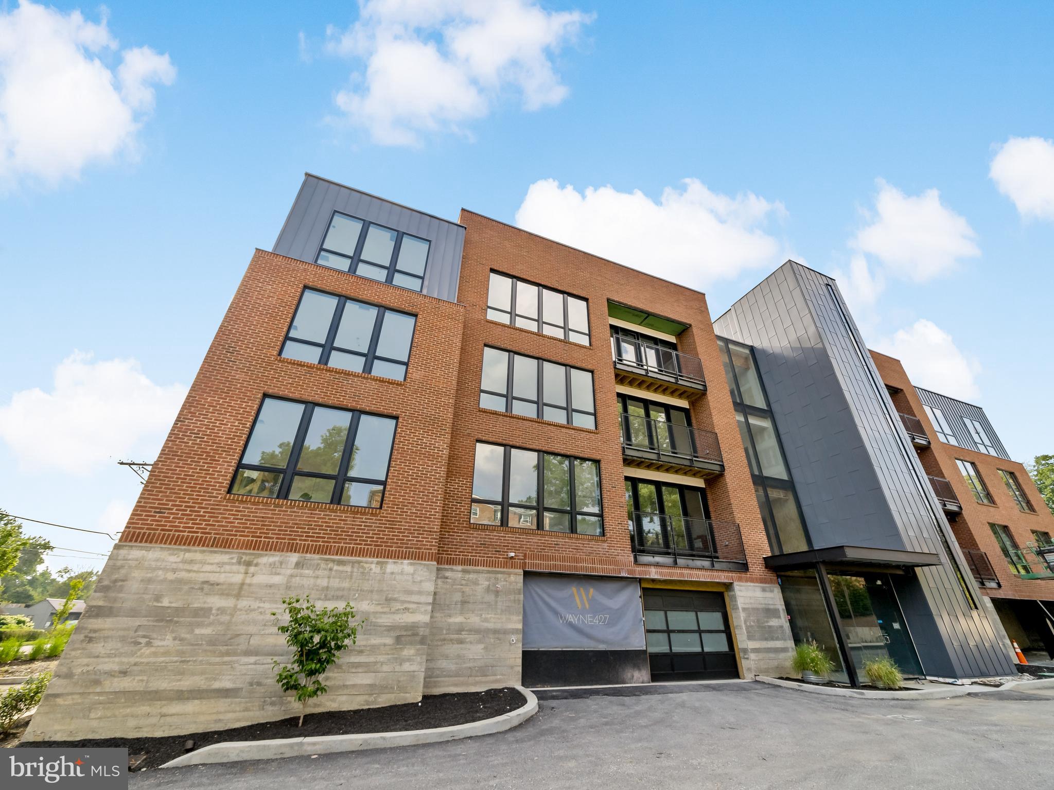 427 Lancaster Avenue, Unit B201 Wayne, PA 19087 - Photo 14 of 18 a front view of a multi story residential apartment building