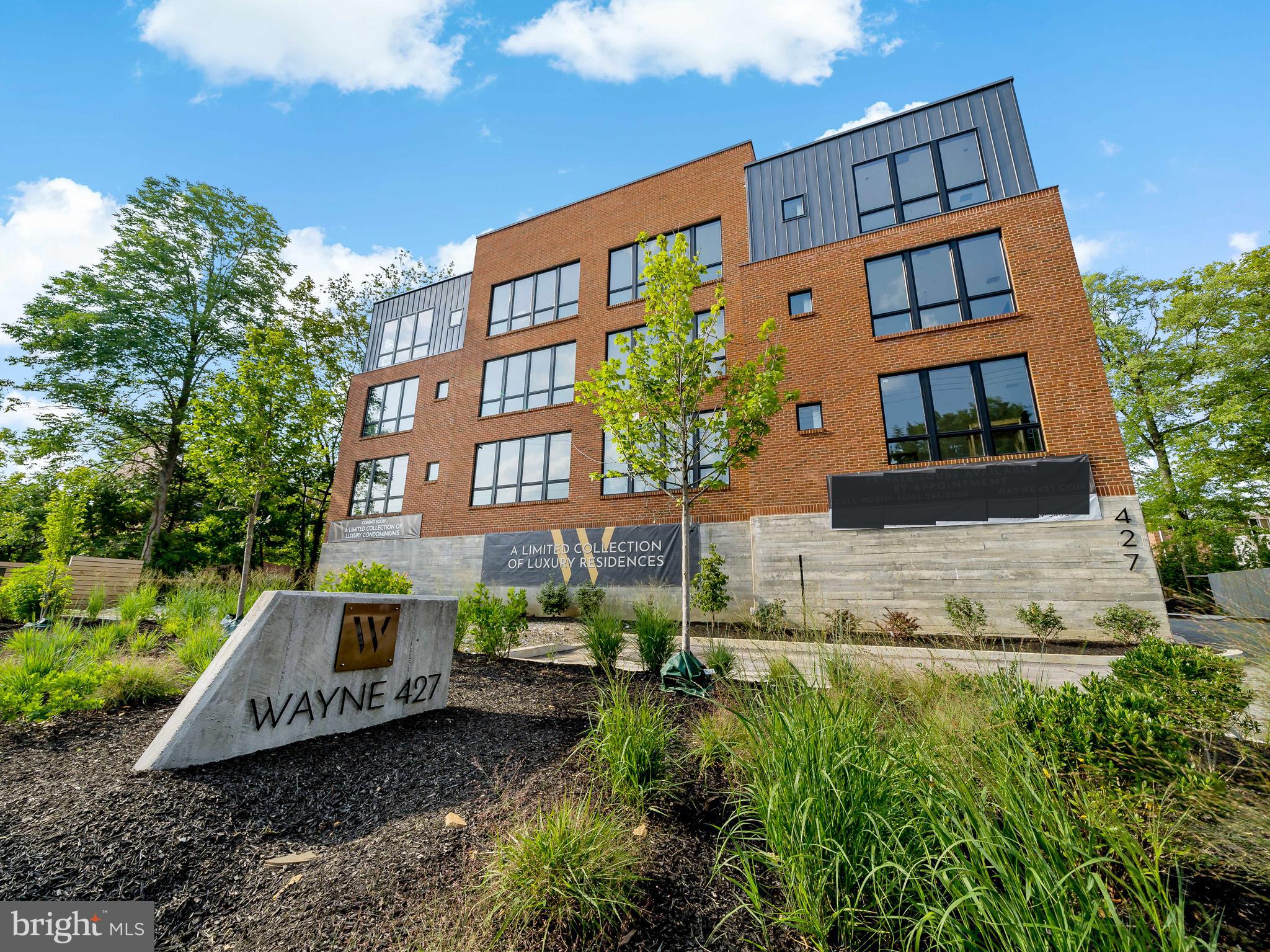 427 Lancaster Avenue, Unit B201 Wayne, PA 19087 - Photo 3 of 18 a front view of a residential apartment building with a yard