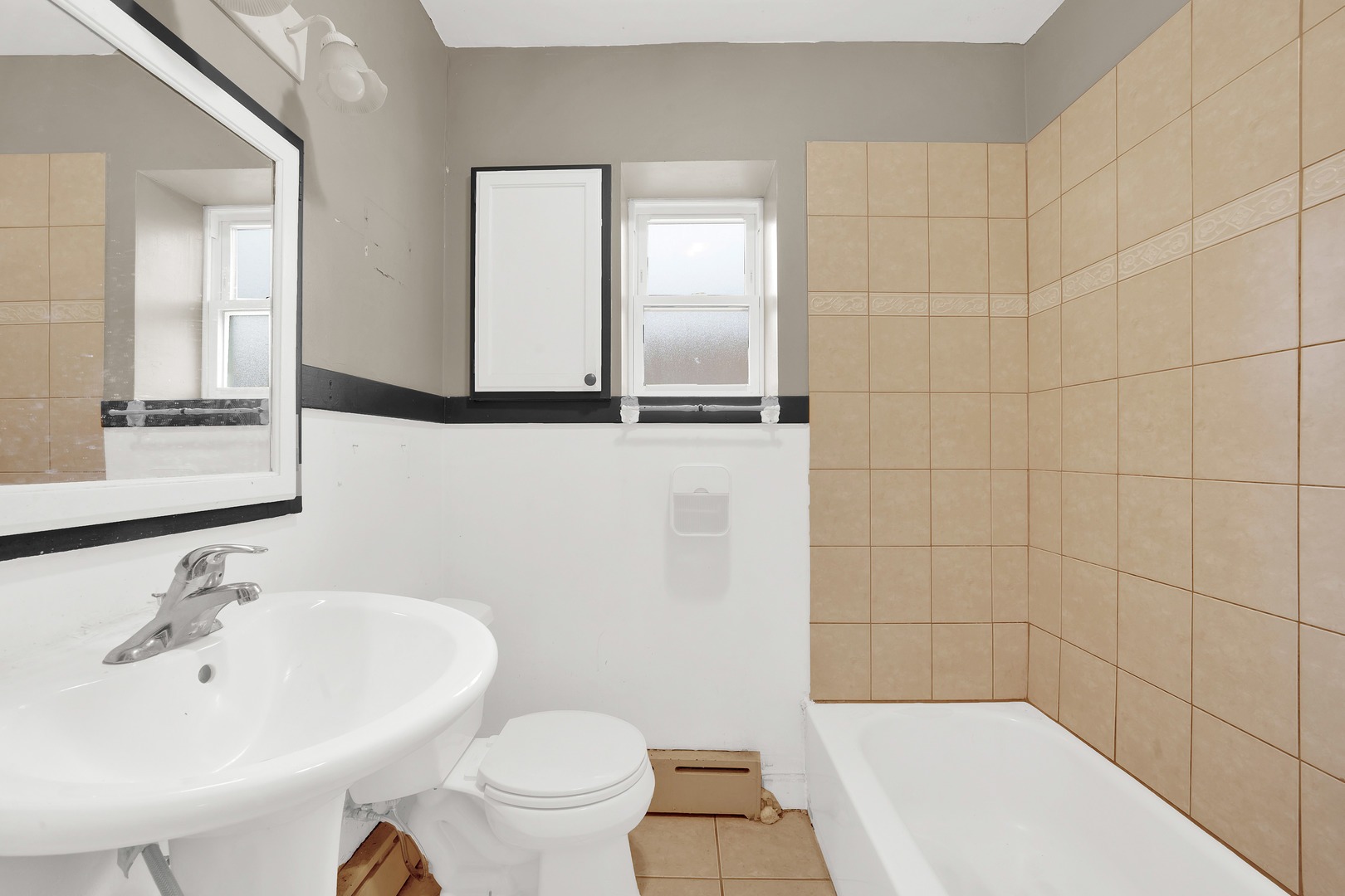 2547 West 51st Street Chicago, IL 60632 - Photo 13 of 19 a bathroom with a sink a toilet and shower