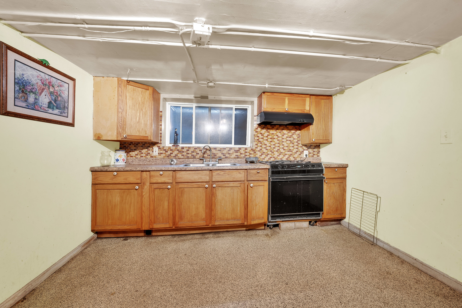 2547 West 51st Street Chicago, IL 60632 - Photo 9 of 19 a kitchen with a stove and white cabinets