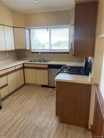 a kitchen with a cabinets a sink and a stove top oven