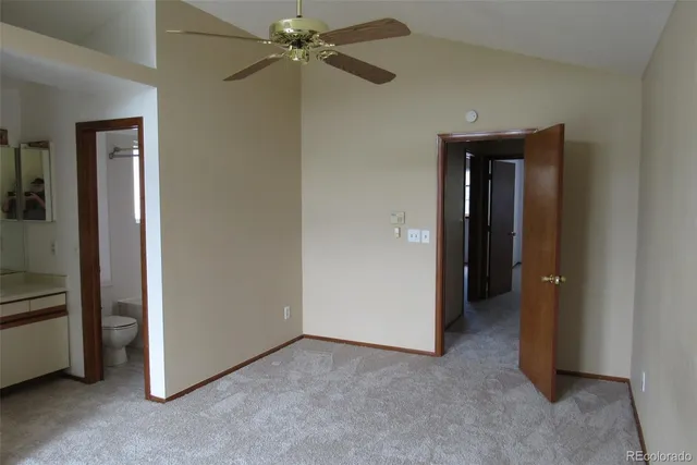 a view of a big room with closet and a chandelier fan