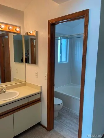 a bathroom with a sink a toilet and bathtub