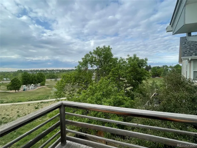 a view of a green field with wooden fence