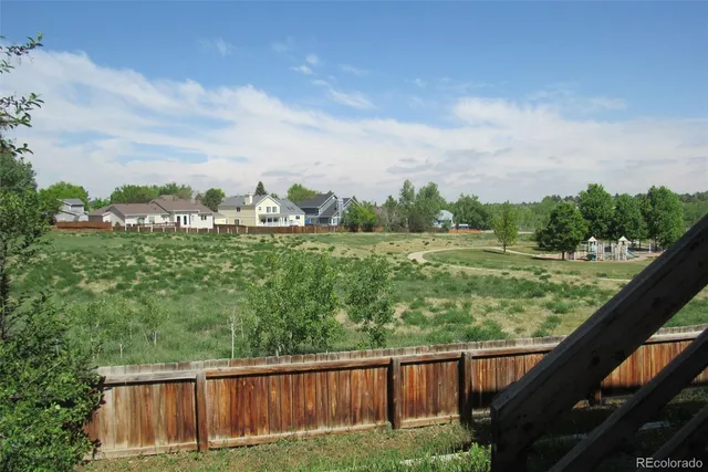 a view of a green field with sitting area