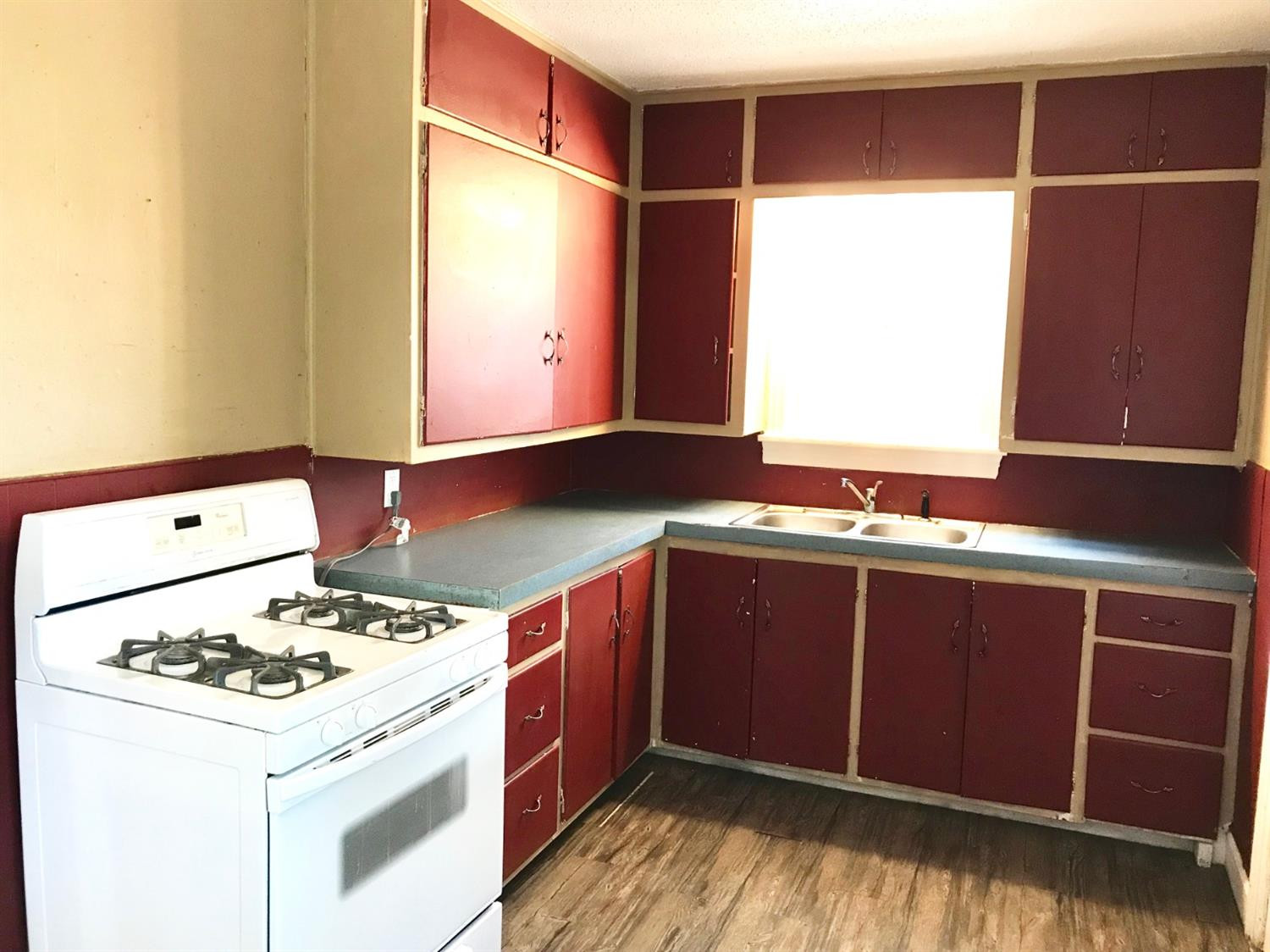 3016 30th Street Lubbock, TX 79410 - Photo 4 of 8 a kitchen with a stove a sink and a refrigerator