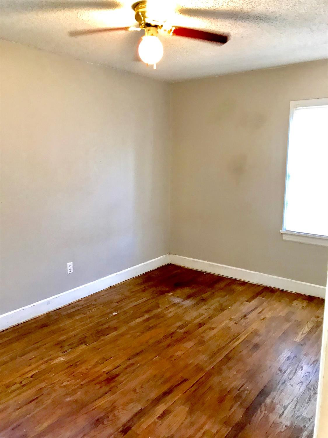 3016 30th Street Lubbock, TX 79410 - Photo 8 of 8 a view of a room with wooden floor and white walls