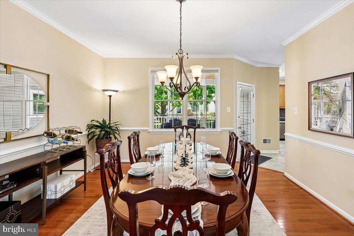 9909 Midsummer Snow Lane Laurel, MD 20723 - Photo 11 of 81 a view of a dining room with furniture window and wooden floor