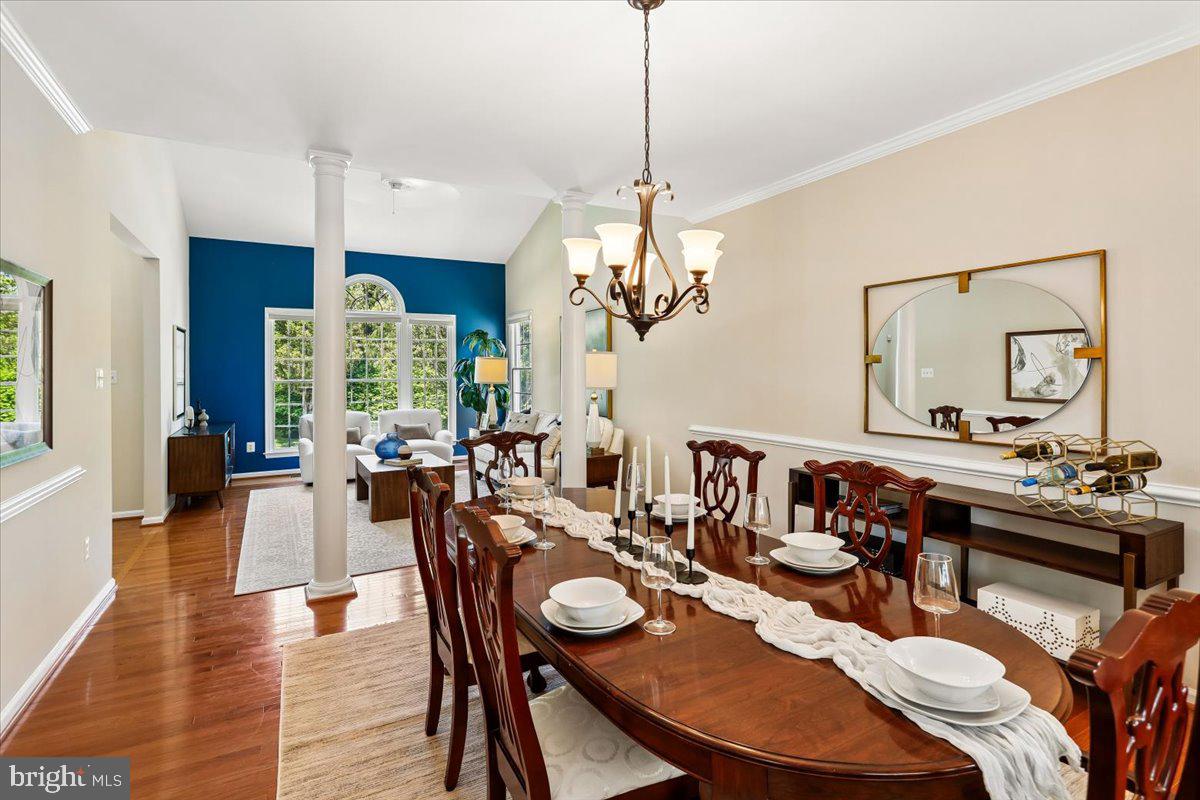 9909 Midsummer Snow Lane Laurel, MD 20723 - Photo 12 of 81 a view of a dining room and livingroom with furniture wooden floor a chandelier