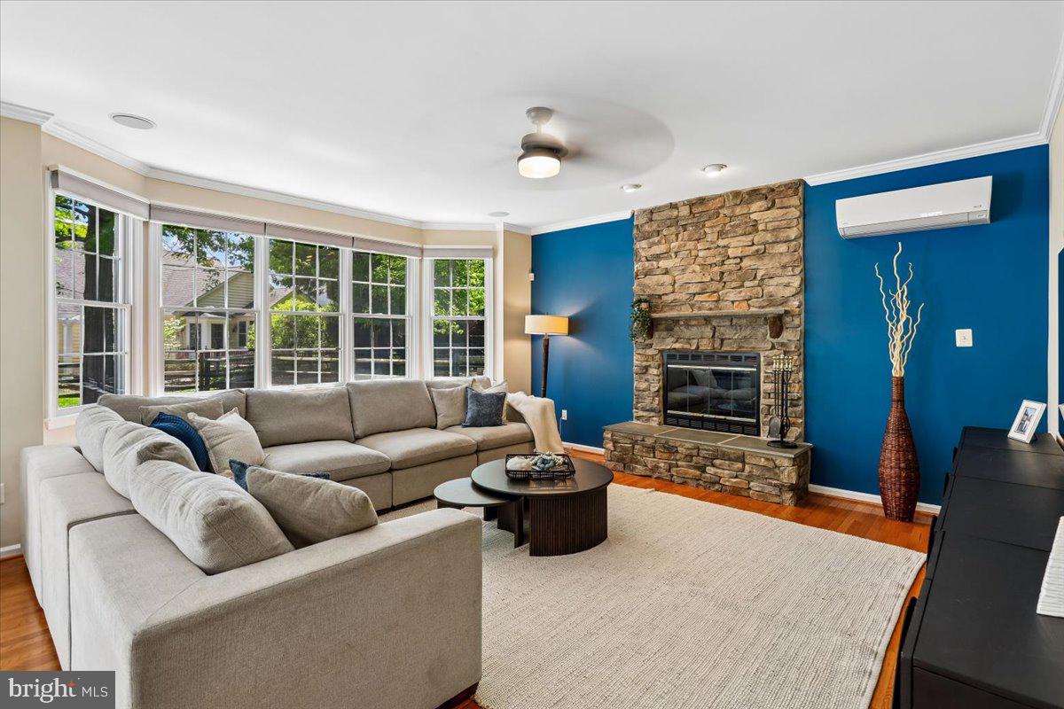 9909 Midsummer Snow Lane Laurel, MD 20723 - Photo 19 of 81 a living room with furniture a fireplace and a large window