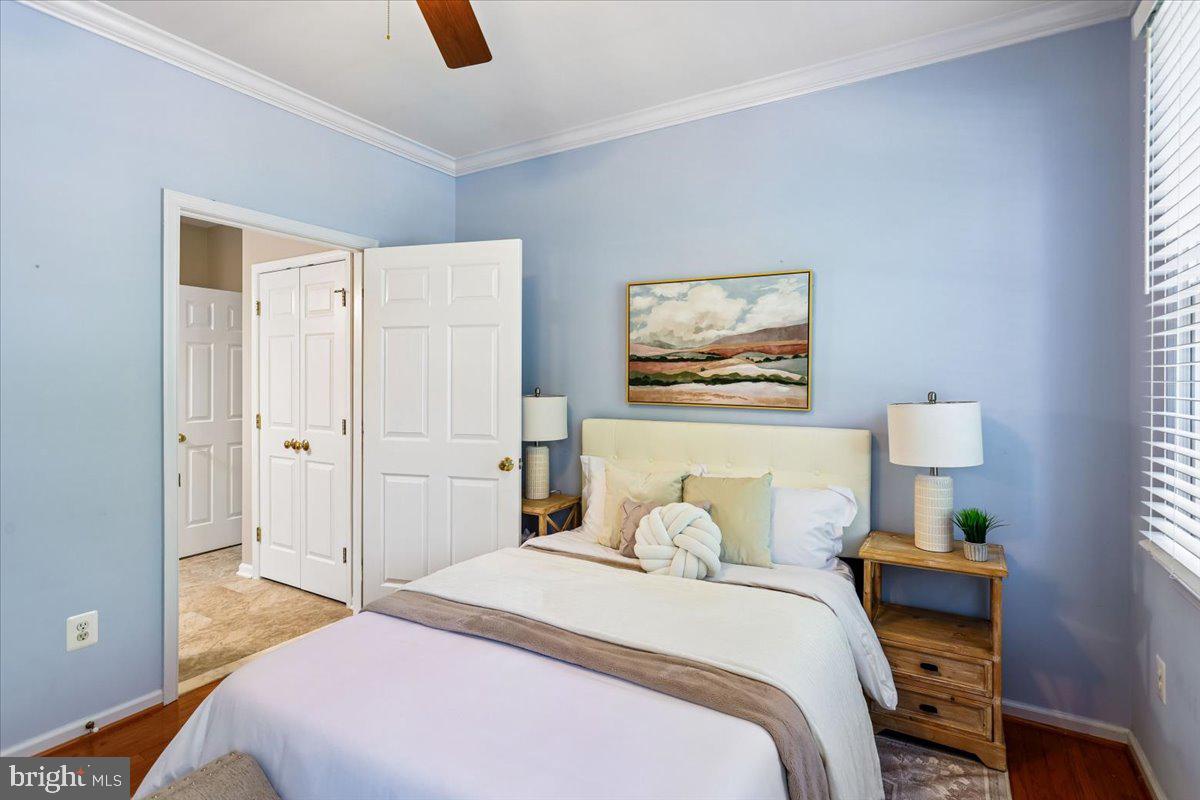 9909 Midsummer Snow Lane Laurel, MD 20723 - Photo 24 of 81 a bedroom with a bed and a painting on the wall