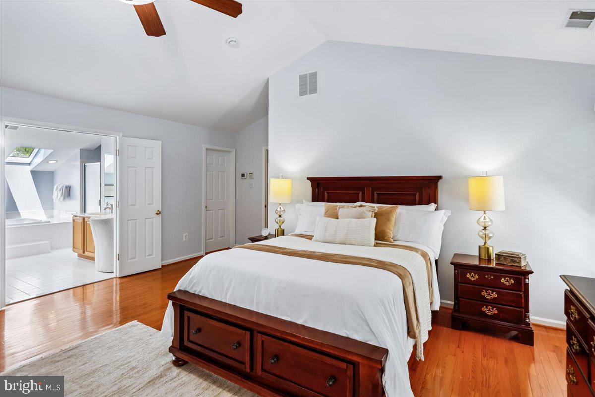 9909 Midsummer Snow Lane Laurel, MD 20723 - Photo 30 of 81 a bedroom with a bed and wooden floor