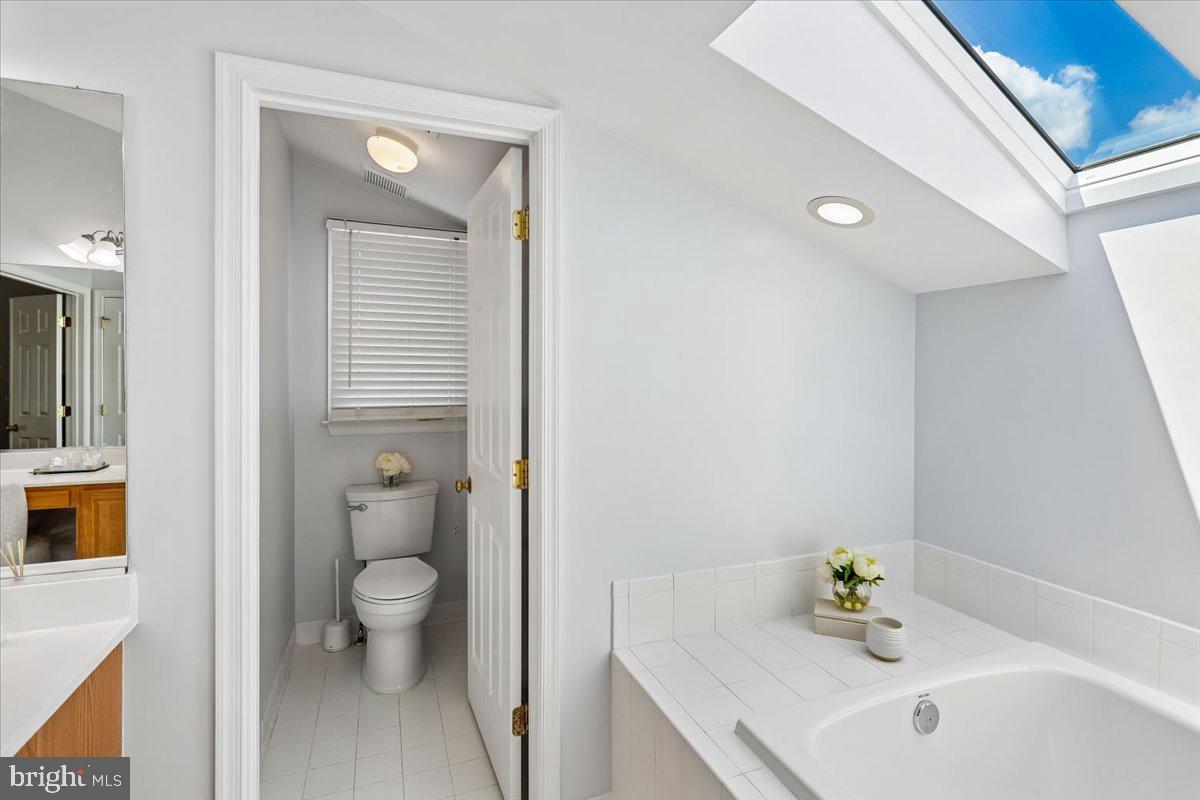 9909 Midsummer Snow Lane Laurel, MD 20723 - Photo 35 of 81 a bathroom with a sink a toilet and shower