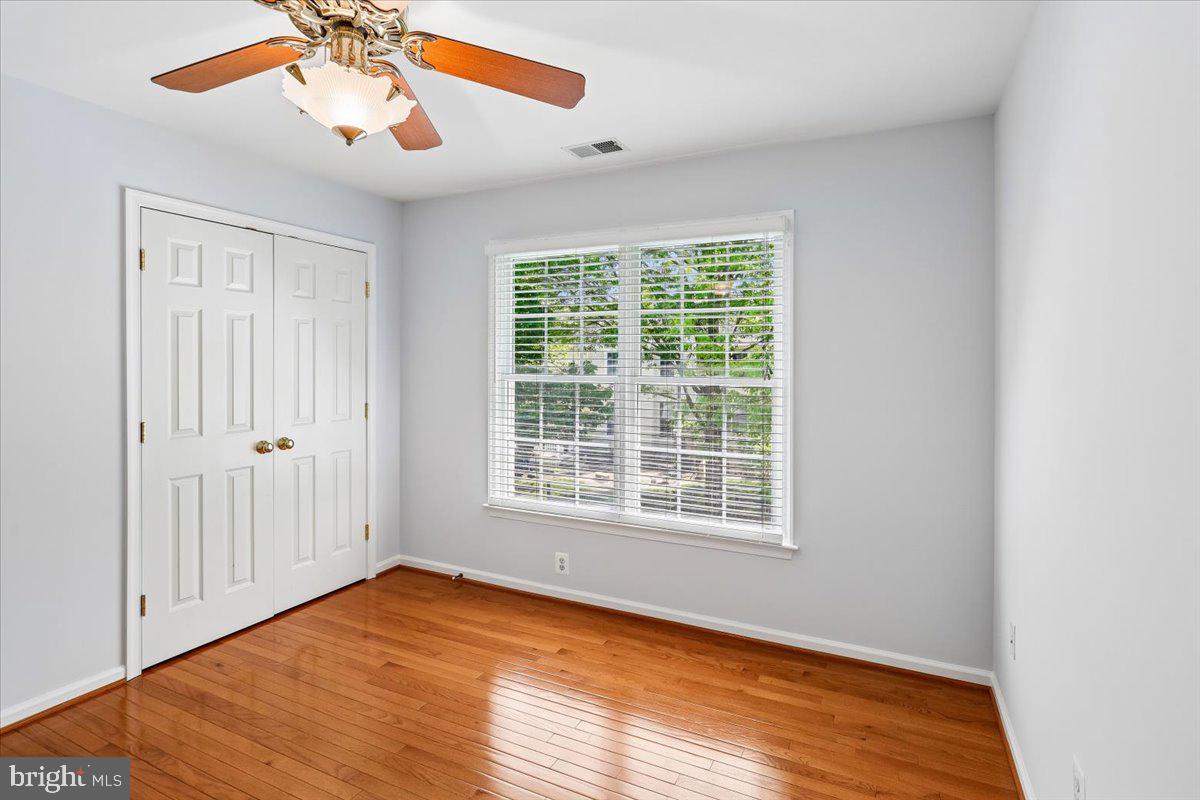 9909 Midsummer Snow Lane Laurel, MD 20723 - Photo 37 of 81 a view of an empty room with wooden floor and a window