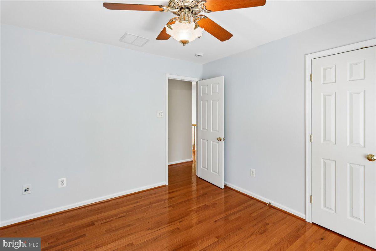 9909 Midsummer Snow Lane Laurel, MD 20723 - Photo 38 of 81 a view of empty room with wooden floor