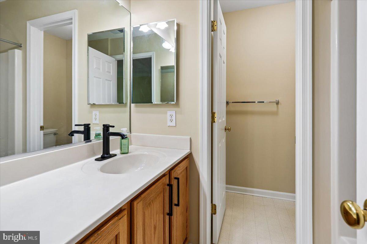 9909 Midsummer Snow Lane Laurel, MD 20723 - Photo 42 of 81 a bathroom with a sink and a mirror