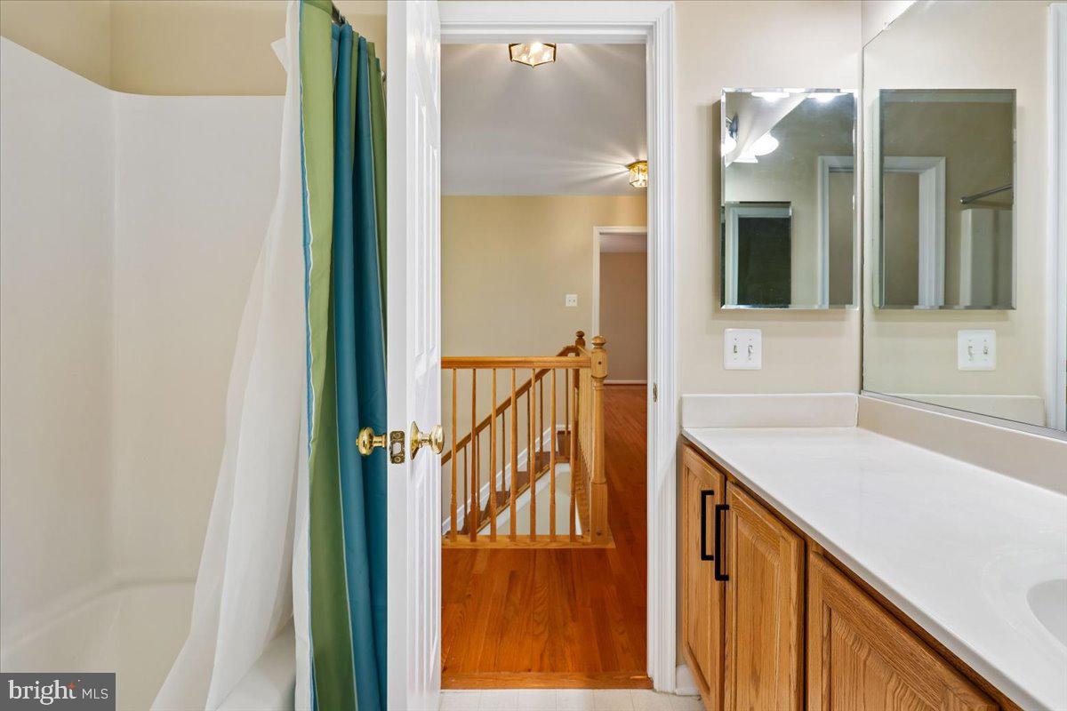 9909 Midsummer Snow Lane Laurel, MD 20723 - Photo 44 of 81 a view of a hallway with wooden floor and staircase