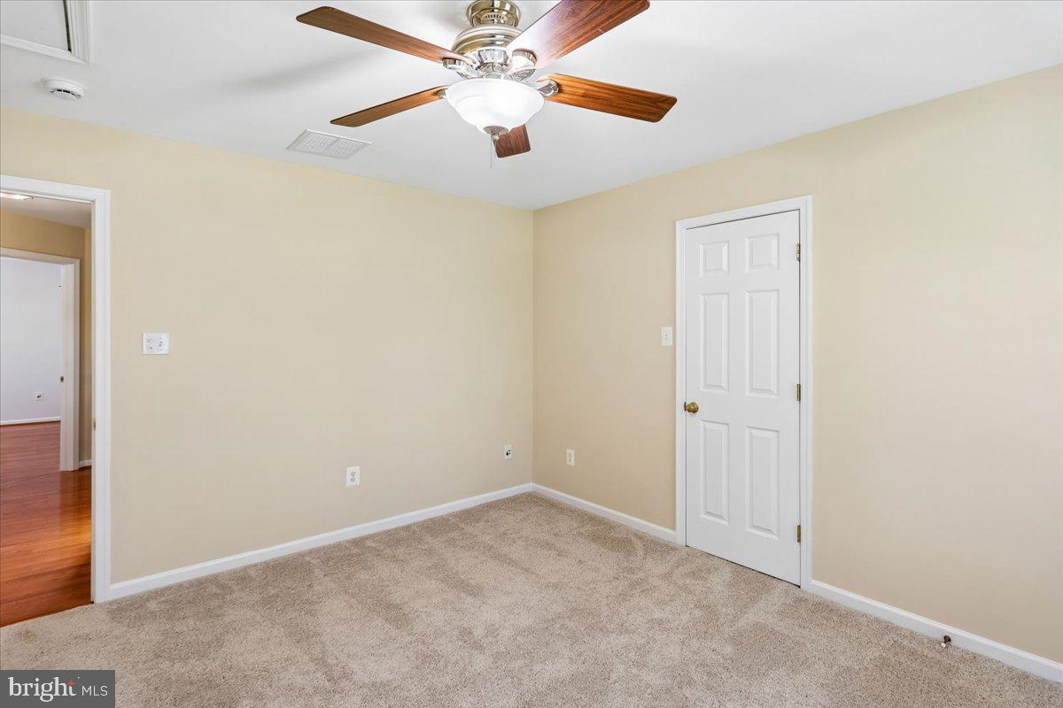 9909 Midsummer Snow Lane Laurel, MD 20723 - Photo 46 of 81 an empty room with closet and a chandelier fan