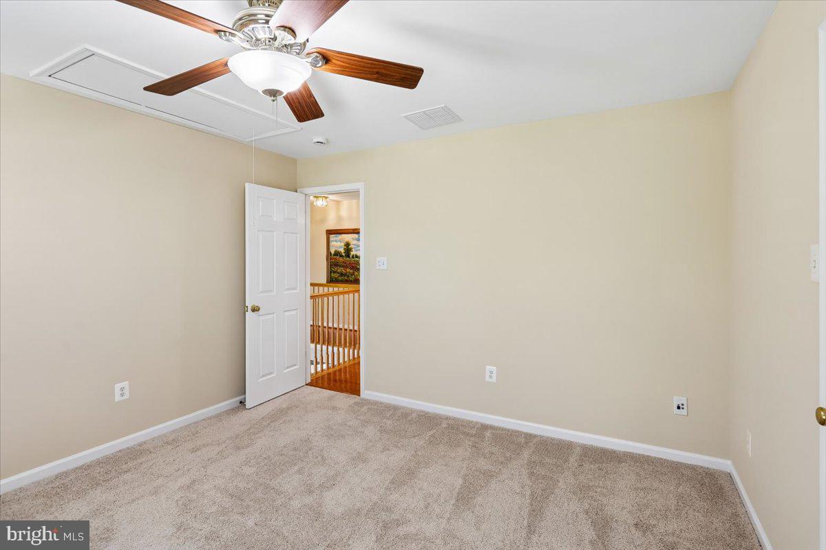 9909 Midsummer Snow Lane Laurel, MD 20723 - Photo 47 of 81 an empty room with closet and a chandelier fan