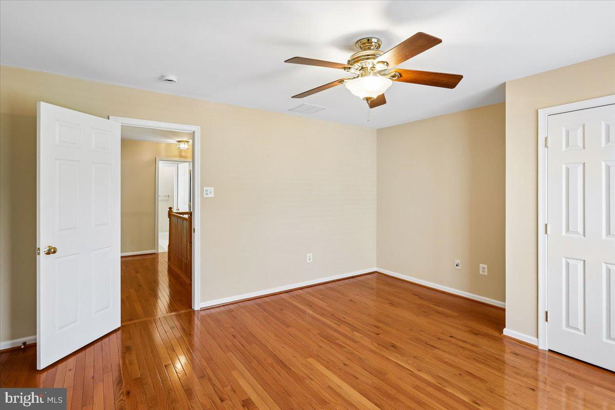 9909 Midsummer Snow Lane Laurel, MD 20723 - Photo 49 of 81 wooden floor in an empty room with a window