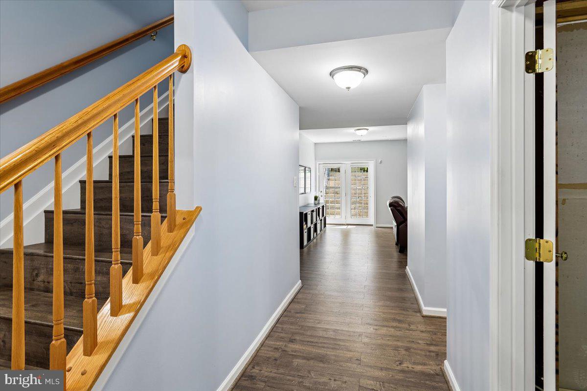 9909 Midsummer Snow Lane Laurel, MD 20723 - Photo 52 of 81 a view of a hallway with wooden floor and staircase