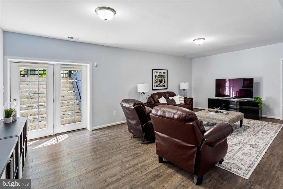 9909 Midsummer Snow Lane Laurel, MD 20723 - Photo 53 of 81 a living room with furniture and a flat screen tv