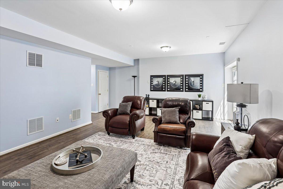 9909 Midsummer Snow Lane Laurel, MD 20723 - Photo 55 of 81 a living room with furniture a rug and a table