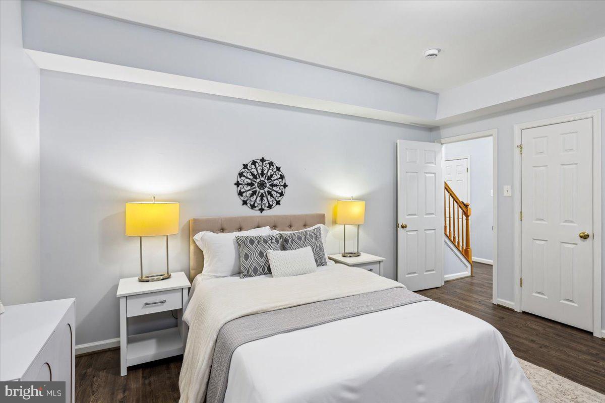 9909 Midsummer Snow Lane Laurel, MD 20723 - Photo 58 of 81 a bedroom with a bed and a lamp on dresser