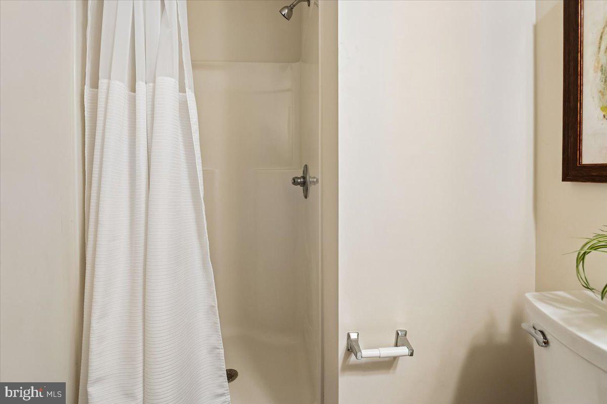 9909 Midsummer Snow Lane Laurel, MD 20723 - Photo 60 of 81 a bathroom with a shower curtain