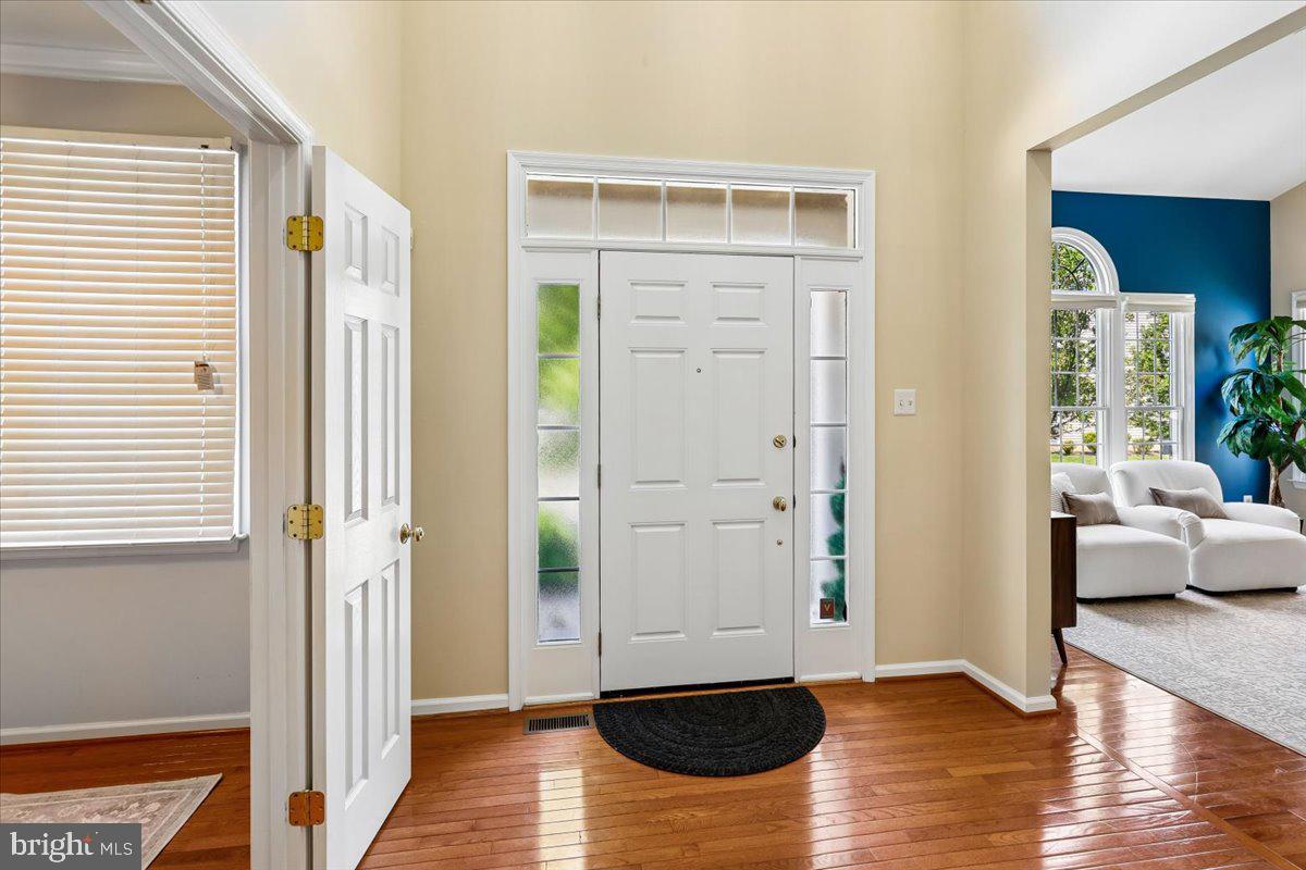 9909 Midsummer Snow Lane Laurel, MD 20723 - Photo 6 of 81 a view of livingroom with furniture and wooden floor
