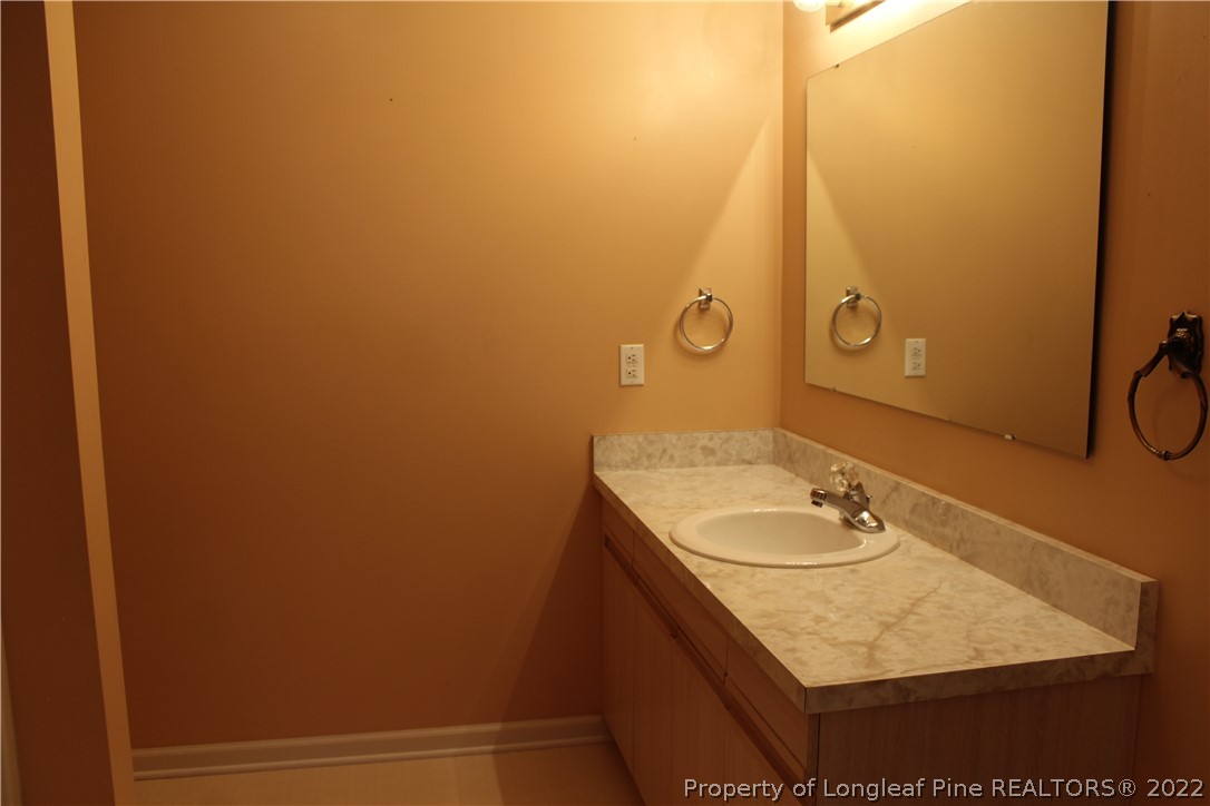 1925 Sardonyx Road, Unit 4 Fayetteville, NC 28303 - Photo 17 of 20 a bathroom with a sink and a mirror