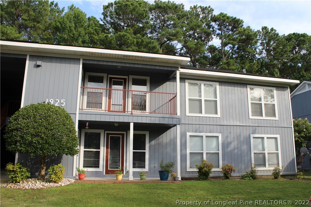 1925 Sardonyx Road, Unit 4 Fayetteville, NC 28303 - Photo 19 of 20 a view of a white house with large windows and a yard