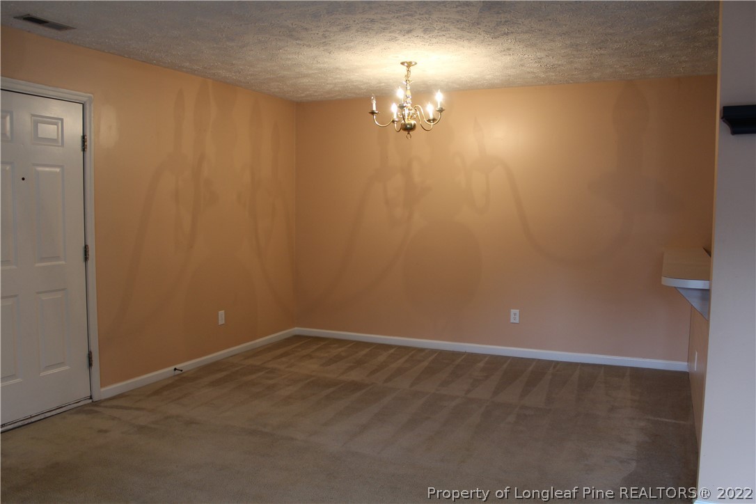 1925 Sardonyx Road, Unit 4 Fayetteville, NC 28303 - Photo 5 of 20 an empty room with a chandelier fan