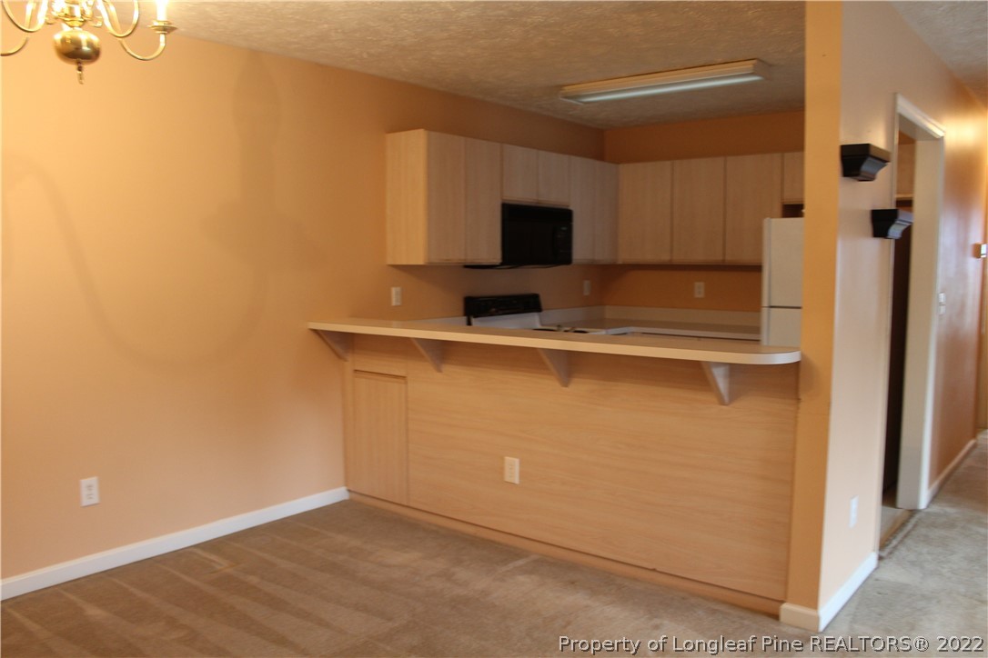 1925 Sardonyx Road, Unit 4 Fayetteville, NC 28303 - Photo 6 of 20 a view of a kitchen with a sink and a refrigerator